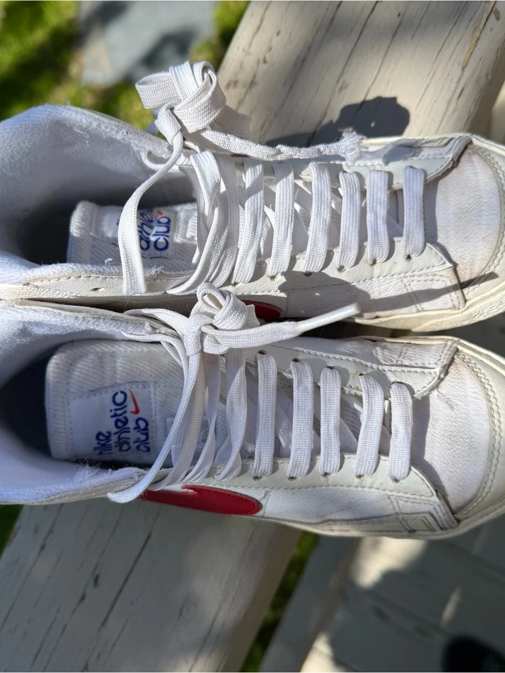 Nike White High-Top Sneakers with Red Swoosh Accent